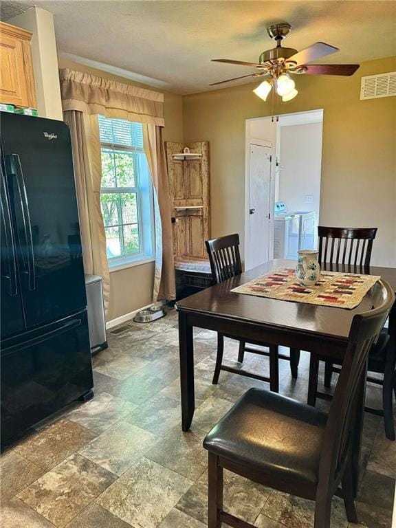 dining area with separate washer and dryer and ceiling fan