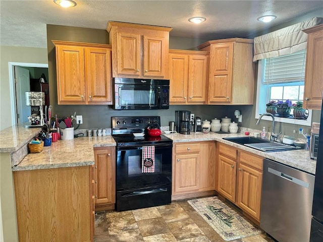 kitchen featuring light stone countertops, sink, kitchen peninsula, a textured ceiling, and black appliances