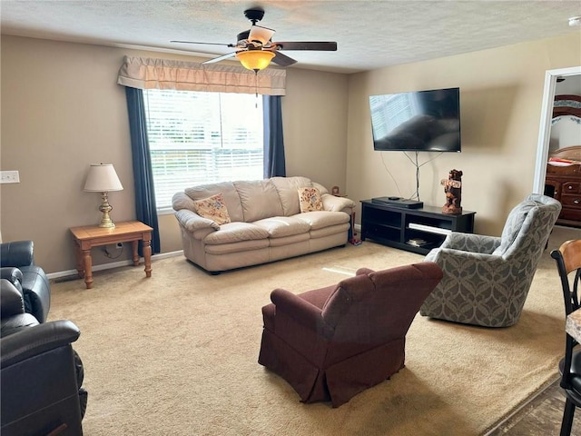 carpeted living room featuring a textured ceiling and ceiling fan