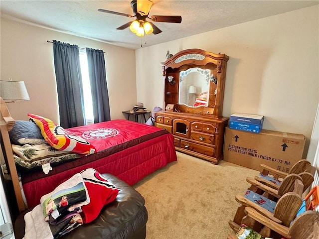 bedroom featuring ceiling fan and carpet