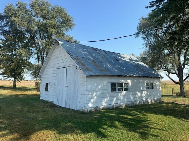 view of outbuilding featuring a yard