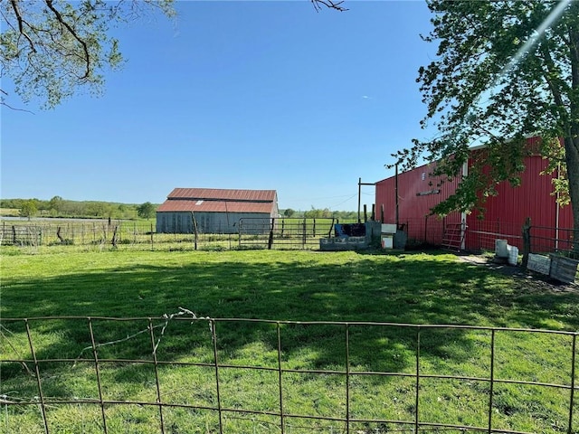 view of yard featuring a rural view and an outdoor structure