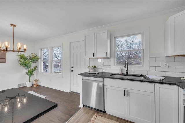 kitchen with stainless steel dishwasher, plenty of natural light, white cabinetry, and sink