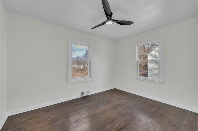 spare room featuring dark hardwood / wood-style flooring and ceiling fan