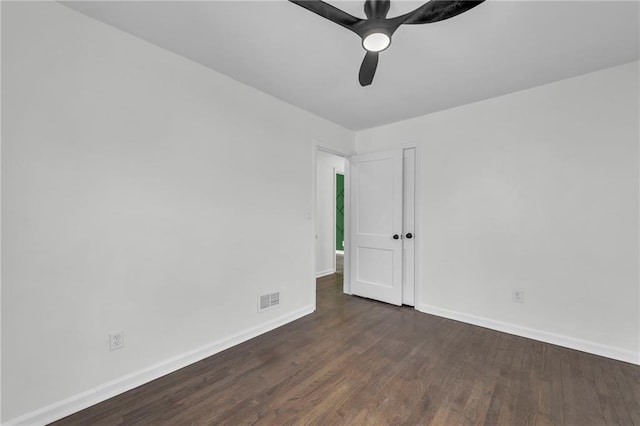 unfurnished room featuring ceiling fan and dark wood-type flooring