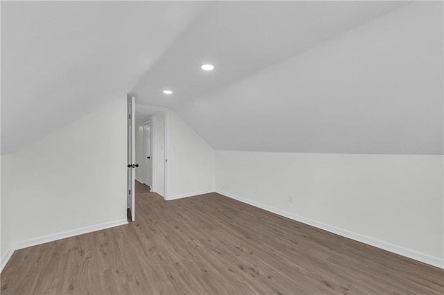 bonus room with hardwood / wood-style floors and lofted ceiling