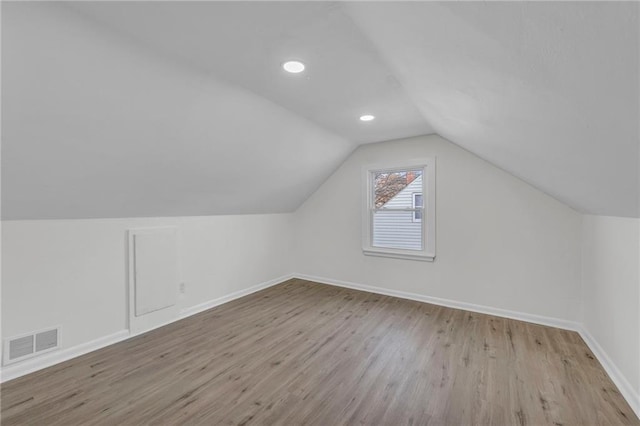 bonus room with light hardwood / wood-style flooring and vaulted ceiling