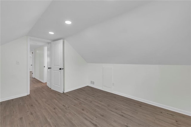 bonus room featuring hardwood / wood-style flooring and vaulted ceiling