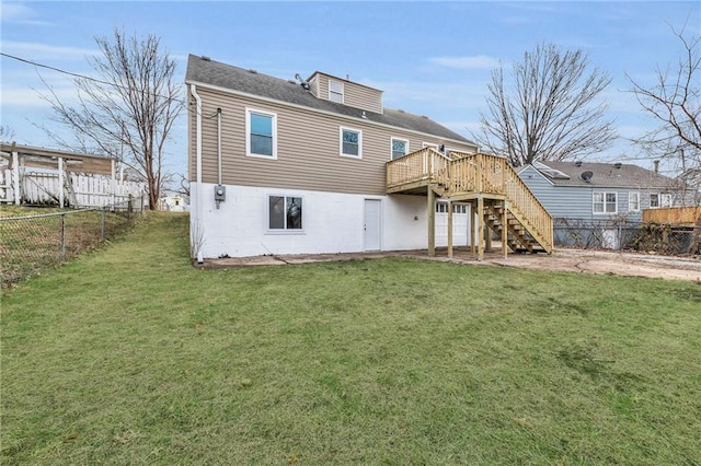 rear view of property featuring a yard and a wooden deck