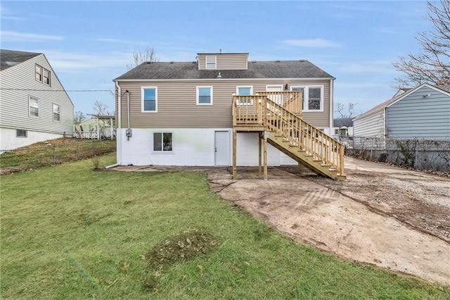 back of house featuring a deck and a yard