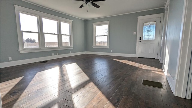 entrance foyer with ceiling fan, dark wood-type flooring, and ornamental molding