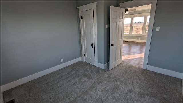 spare room featuring ceiling fan and dark hardwood / wood-style flooring