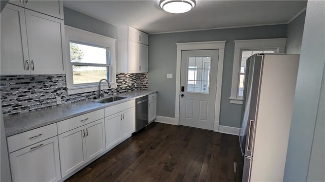 kitchen with dark wood-type flooring, sink, dishwasher, white fridge, and white cabinetry