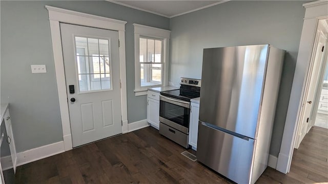 kitchen featuring white cabinets, dark hardwood / wood-style floors, ornamental molding, and appliances with stainless steel finishes