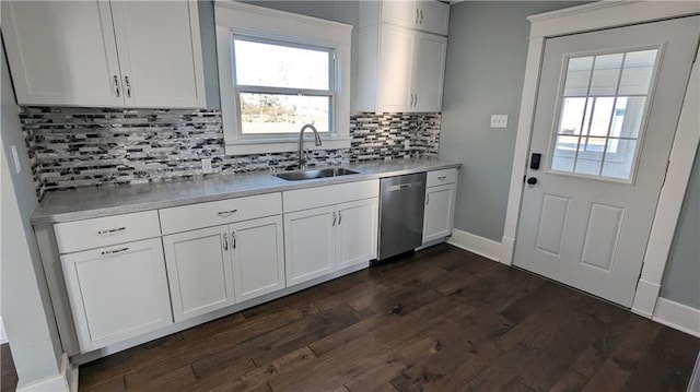 kitchen with stainless steel dishwasher, white cabinets, and sink