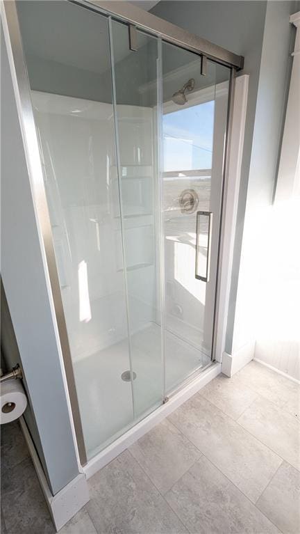 bathroom with tile patterned flooring, plenty of natural light, and an enclosed shower