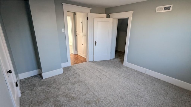 unfurnished bedroom featuring a closet and carpet floors