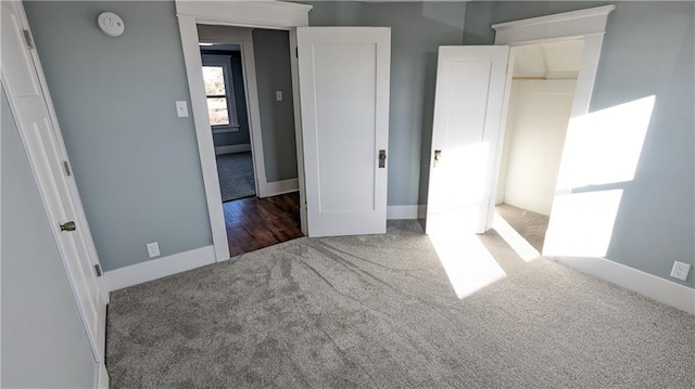 unfurnished bedroom featuring dark colored carpet