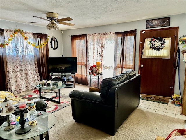 carpeted living room with ceiling fan and a textured ceiling