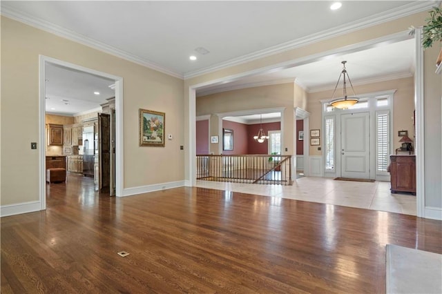 entryway featuring ornamental molding, hardwood / wood-style floors, and plenty of natural light