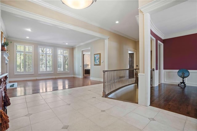 interior space featuring crown molding and light tile patterned floors