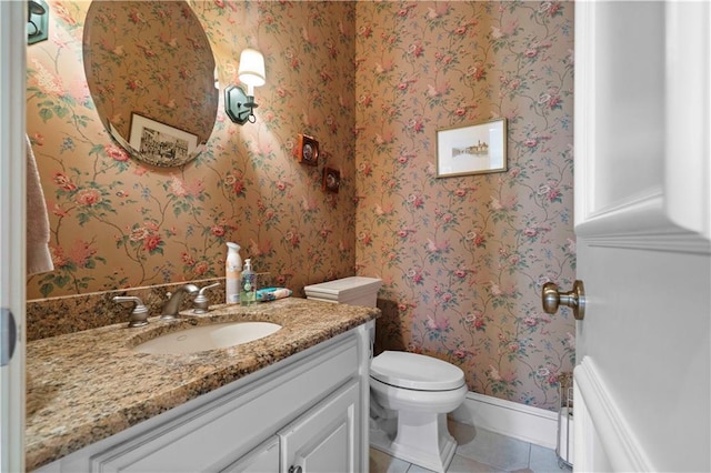 bathroom featuring tile patterned flooring, vanity, and toilet