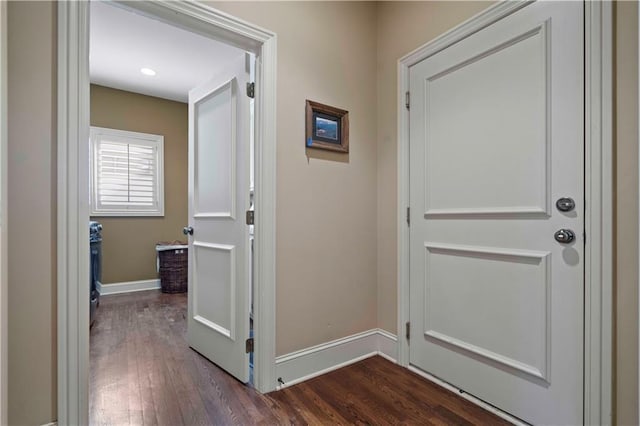 hallway with dark hardwood / wood-style flooring