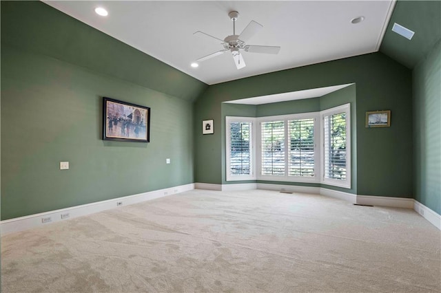 carpeted empty room with lofted ceiling and ceiling fan