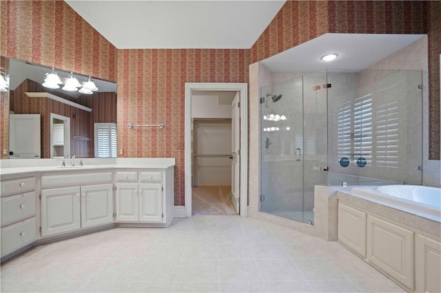 bathroom featuring vanity and independent shower and bath