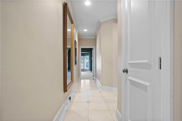 hall with ornamental molding and light tile patterned floors