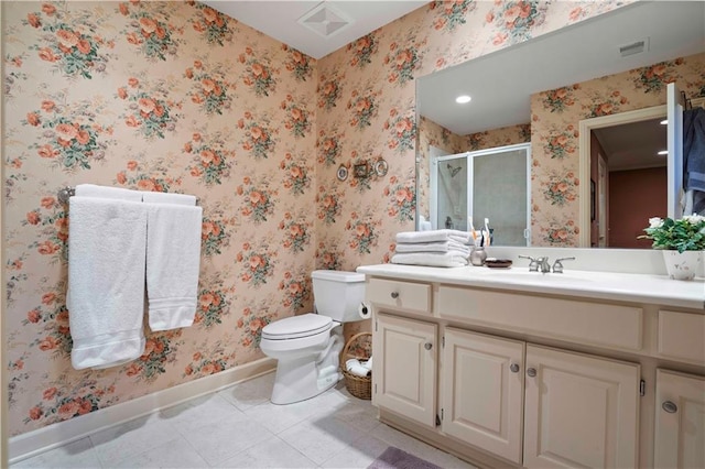 bathroom featuring tile patterned flooring, vanity, toilet, and walk in shower