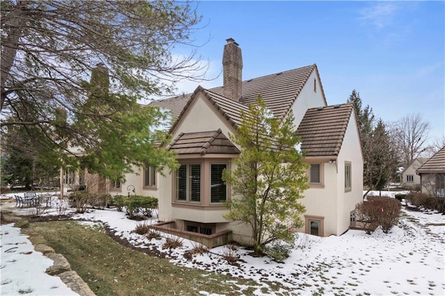 view of snow covered rear of property