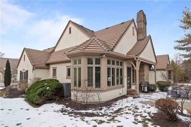 view of snowy exterior with central AC