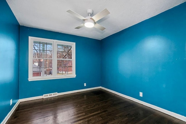 empty room featuring hardwood / wood-style floors and ceiling fan