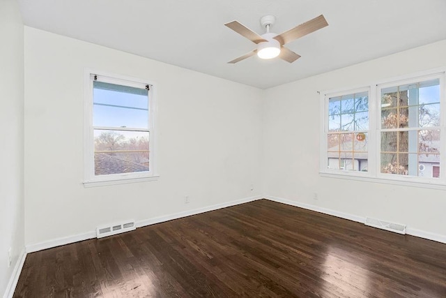 empty room with hardwood / wood-style floors and ceiling fan