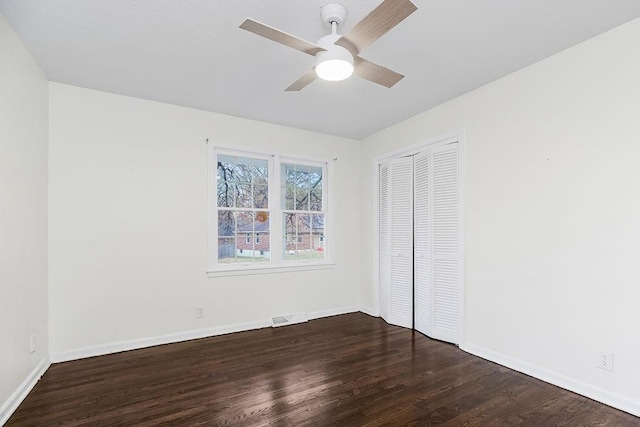 unfurnished bedroom featuring ceiling fan, dark wood-type flooring, and a closet