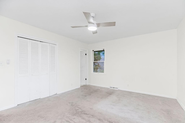 unfurnished bedroom featuring ceiling fan, a closet, and carpet floors