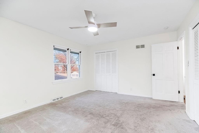 unfurnished bedroom with ceiling fan and light carpet