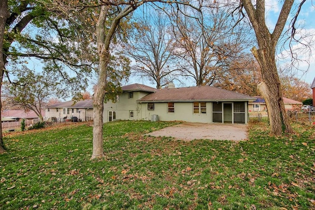 rear view of house with a patio area, a sunroom, and a yard