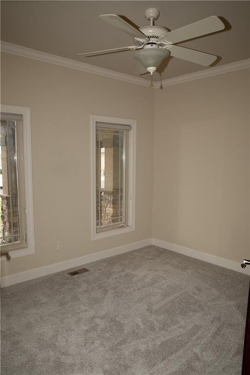 carpeted empty room featuring ceiling fan and ornamental molding