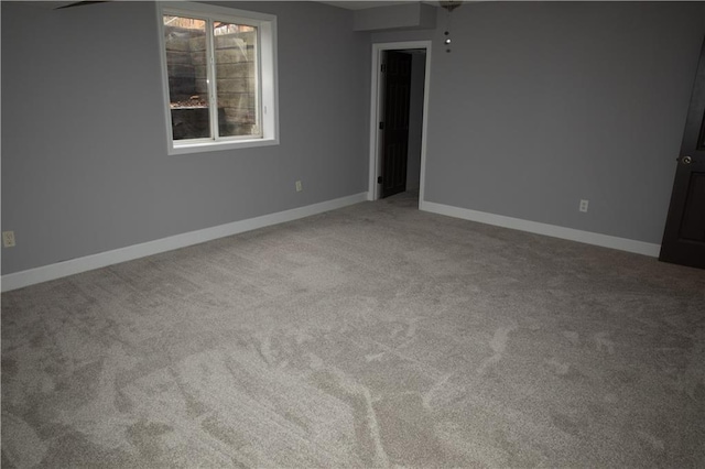 unfurnished room featuring carpet floors and ceiling fan