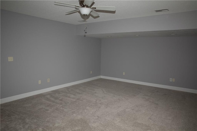 carpeted spare room featuring ceiling fan