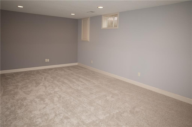 basement featuring light colored carpet