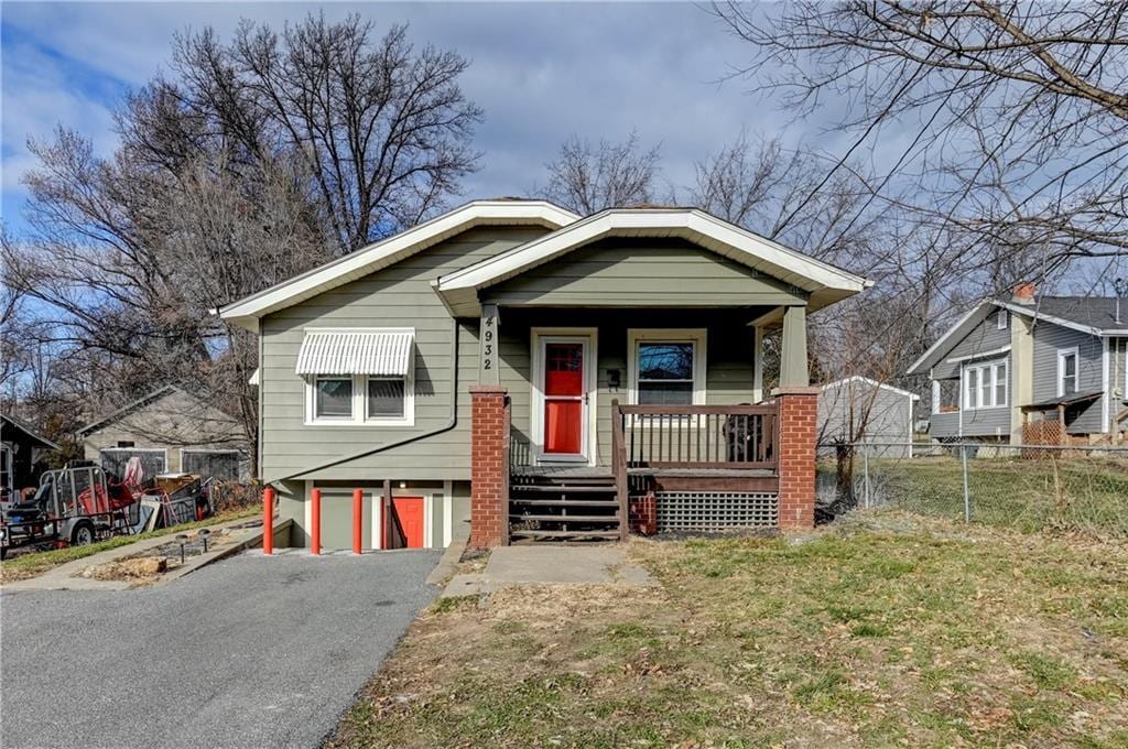 bungalow featuring covered porch and a garage