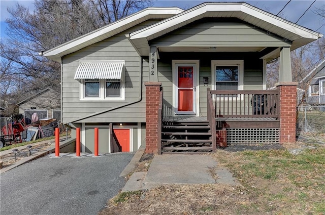 bungalow featuring a porch and a garage