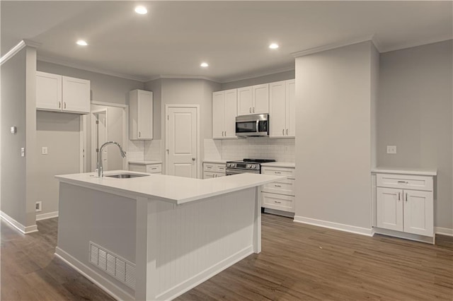 kitchen featuring a kitchen island with sink, white cabinets, stainless steel appliances, and dark hardwood / wood-style floors