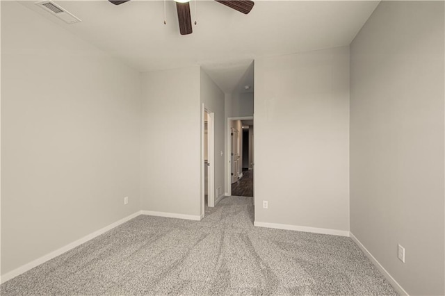 empty room with ceiling fan and light carpet