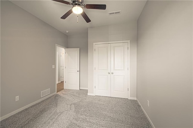 unfurnished bedroom featuring ceiling fan, a closet, and carpet