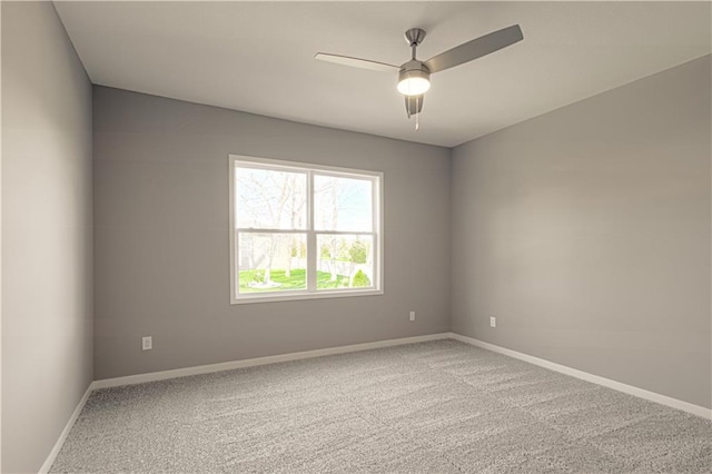 empty room with carpet flooring and ceiling fan