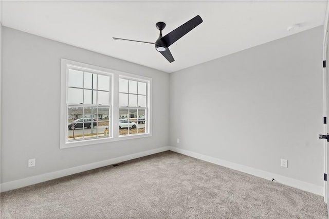 empty room featuring ceiling fan and carpet floors